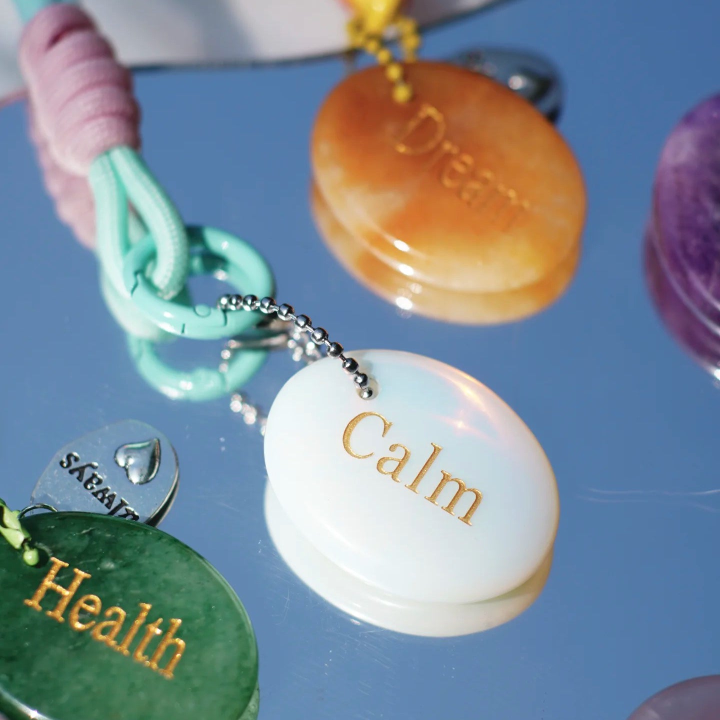 Assorted affirmation crystal keychains in mixed pastel colors