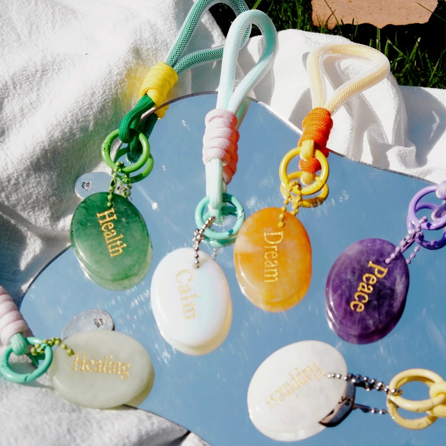 Colorful affirmation crystal charms glowing in natural sunlight