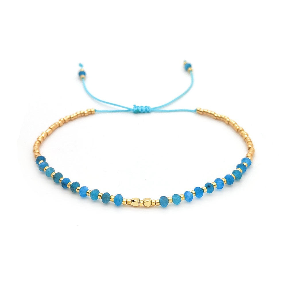 Adjustable bracelet with blue apatite stones and gold accents