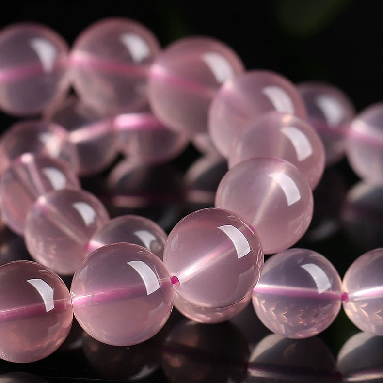Detailed view of round Rose Quartz beads showing natural clarity and color
