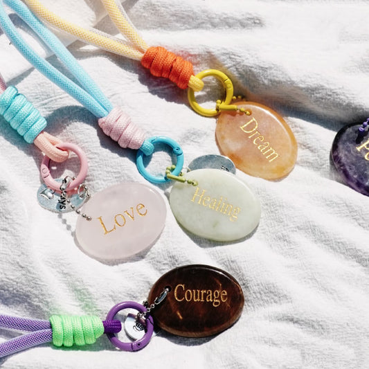 Assorted affirmation crystal keychains in mixed pastel colors
