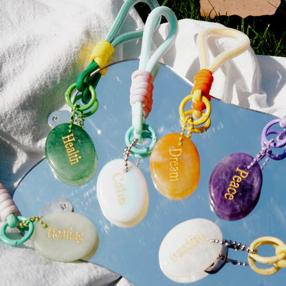 Colorful affirmation crystal charms glowing in natural sunlight

