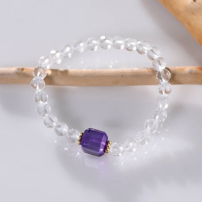 Crystal healing bracelet featuring clear quartz and amethyst in natural setting

