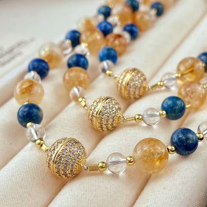 Close-up of citrine and lapis lazuli crystal necklace beads
