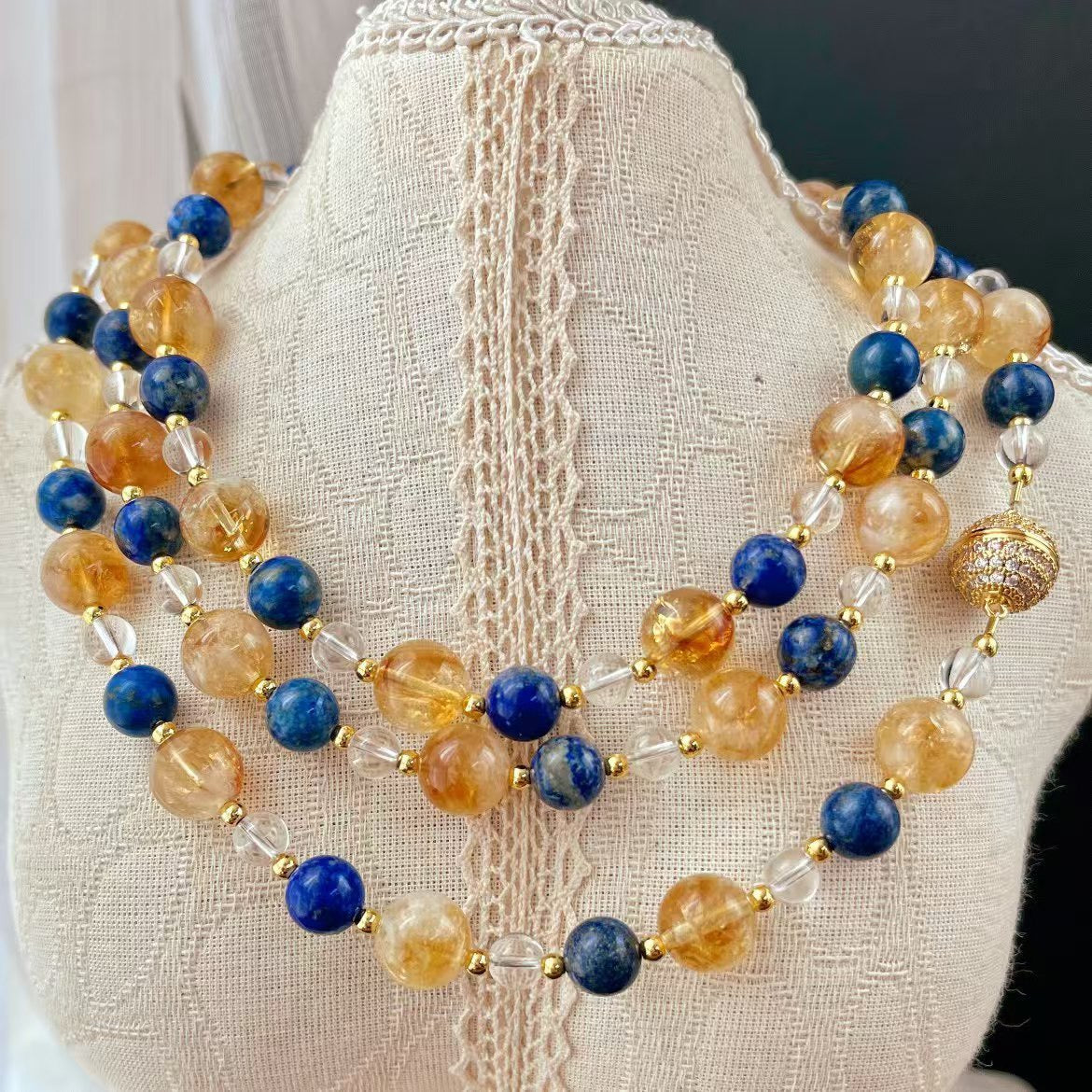 Lapis lazuli and citrine set displayed on mannequin bust

