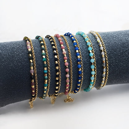 Assorted healing crystal gemstone bracelets displayed on velvet roll