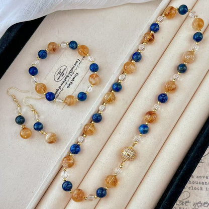 Full crystal set (necklace, bracelet, earrings) flatlay in box
