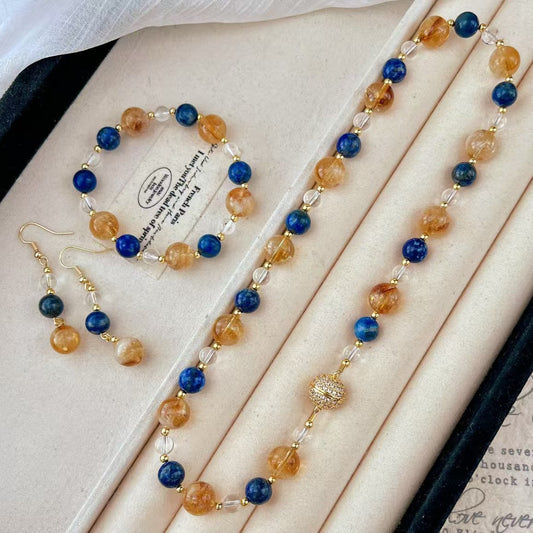 Full crystal set (necklace, bracelet, earrings) flatlay in box
