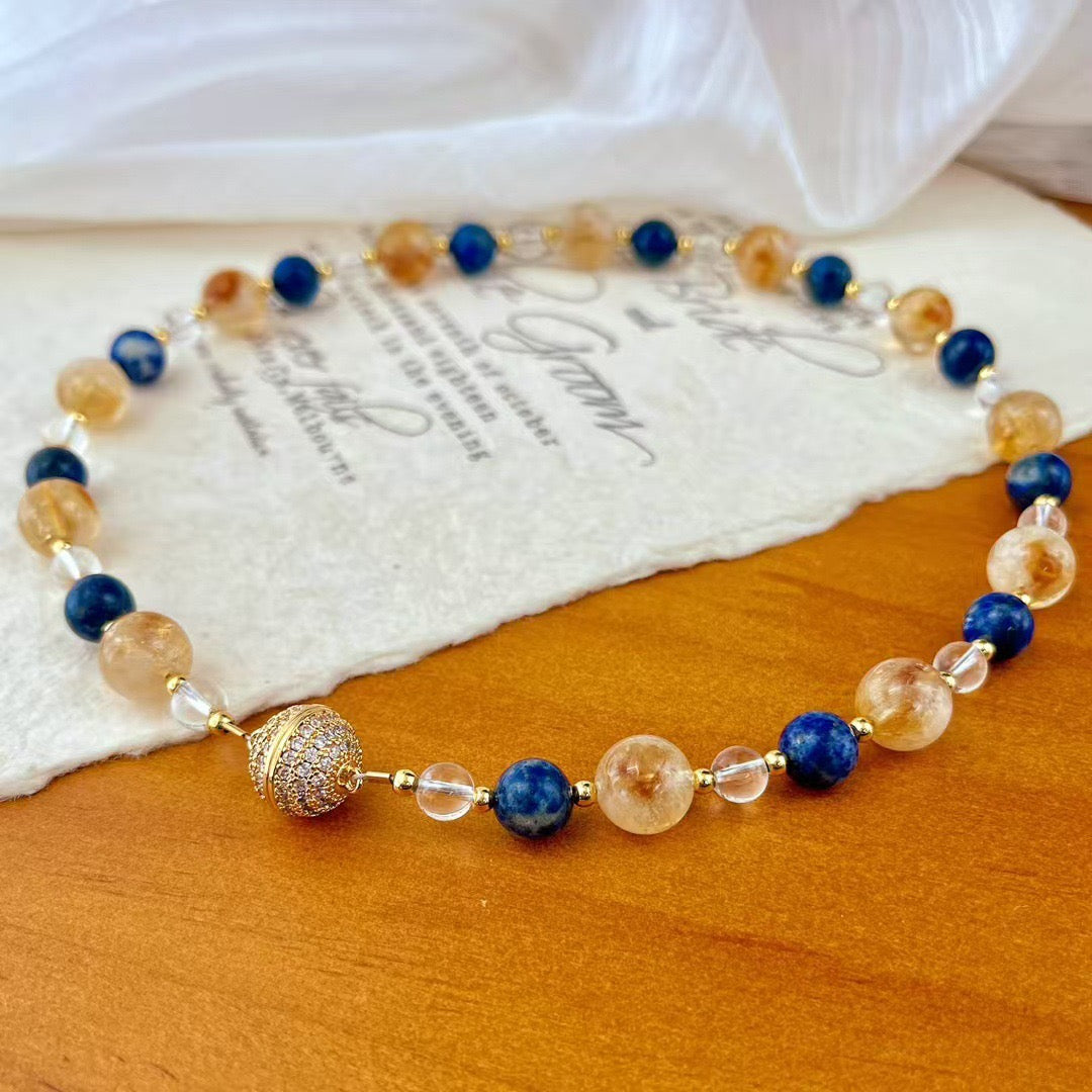 Crystal necklace and bracelet on wooden surface
