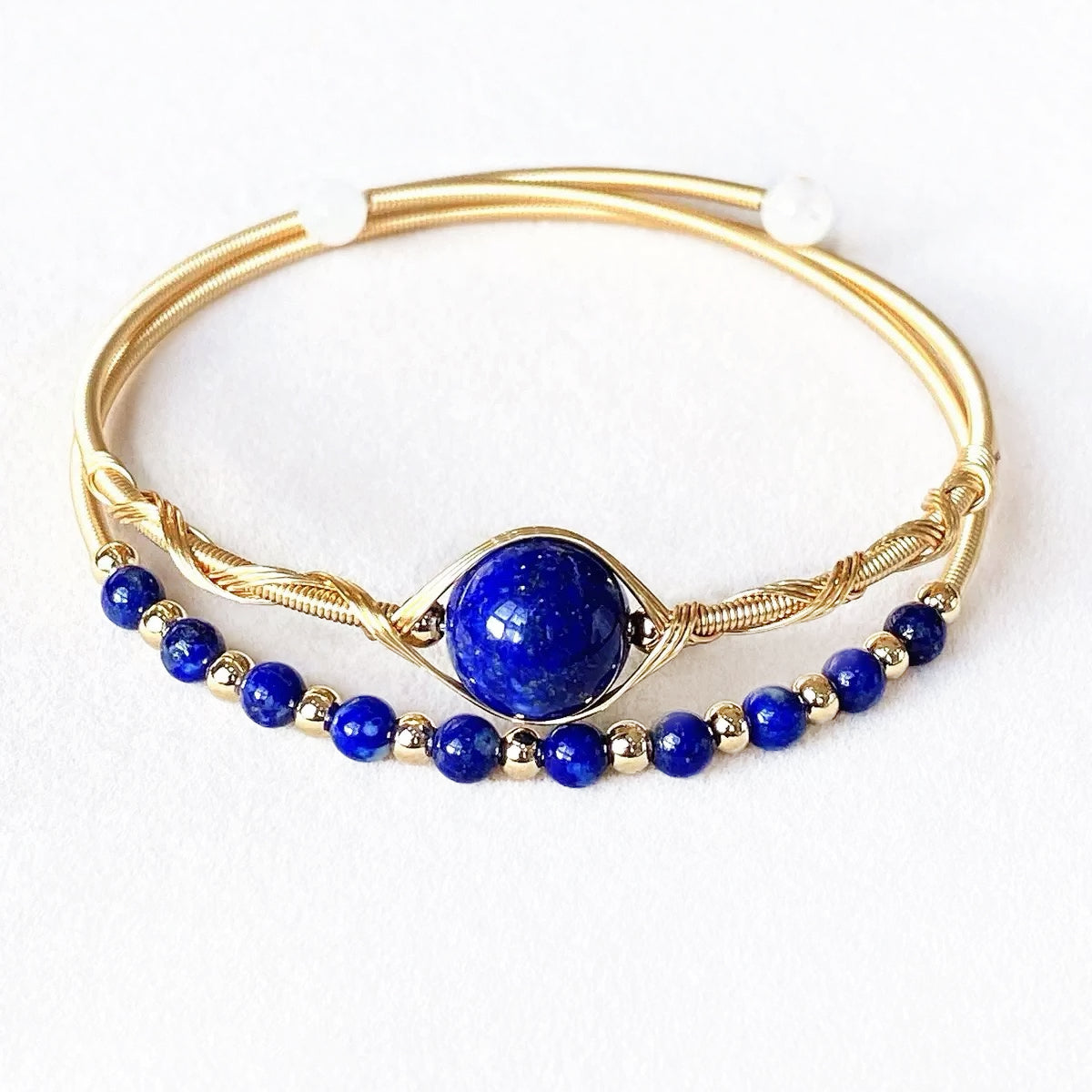 Royal blue lapis lazuli bangle with gold wire wrap