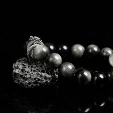 Side angle of black crystal bracelet with blue labradorite glow