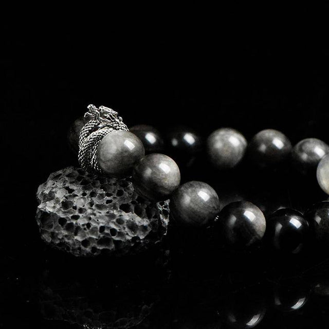 Side angle of black crystal bracelet with blue labradorite glow