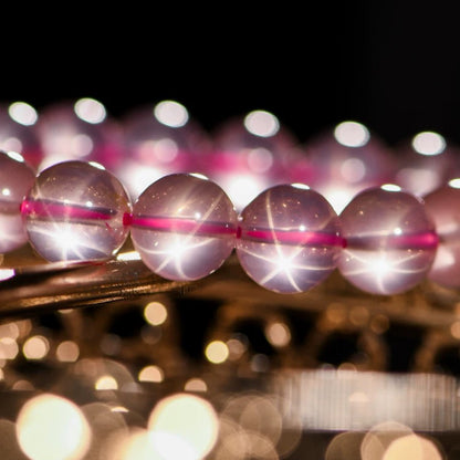 Close-up of sparkling Rose Quartz beads under soft lighting