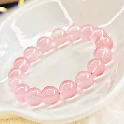 Rose Quartz Bracelet in a white ceramic bowl, showing soft pink glow