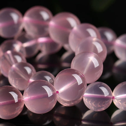Detailed view of round Rose Quartz beads showing natural clarity and color