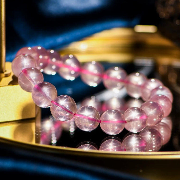 Rose Quartz Bracelet placed on a golden jewelry box, elegant and radiant
