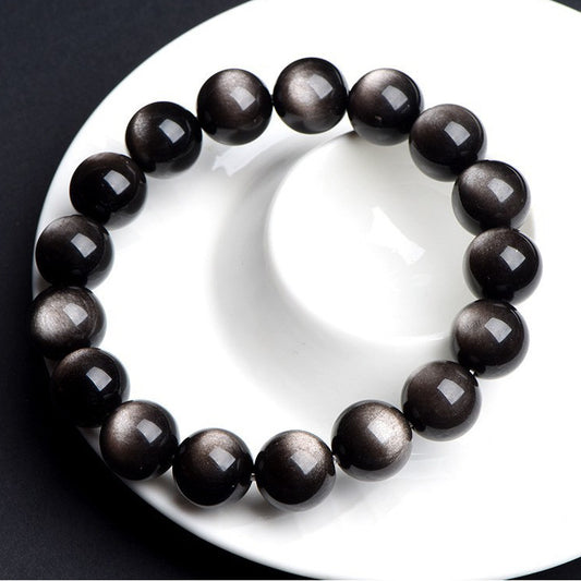 Obsidian bracelet displayed on white plate
