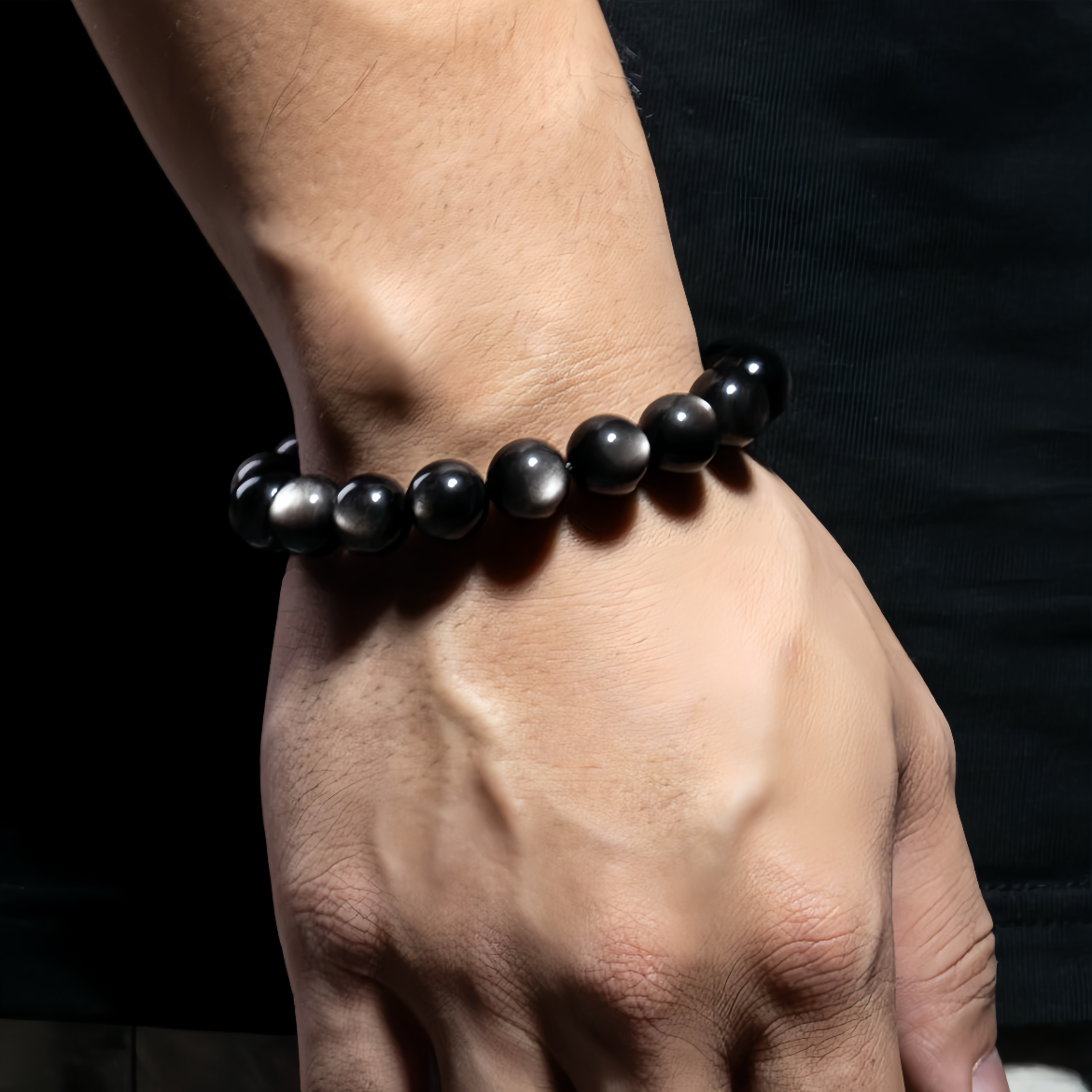 Man wearing Silver Sheen Obsidian bracelet on wrist front
