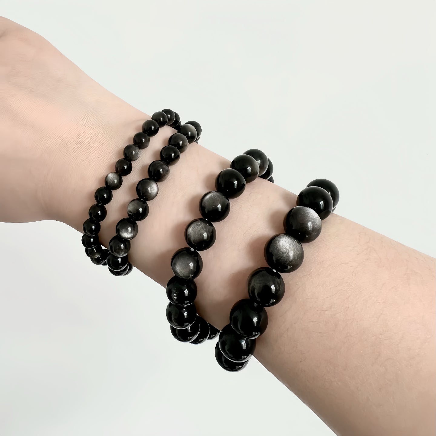 Side view of Silver Sheen Obsidian bracelet on male wrist

