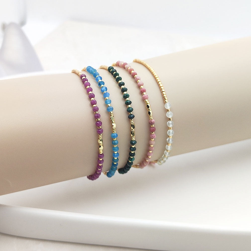 Stacked crystal bracelets with multiple colors on wrist