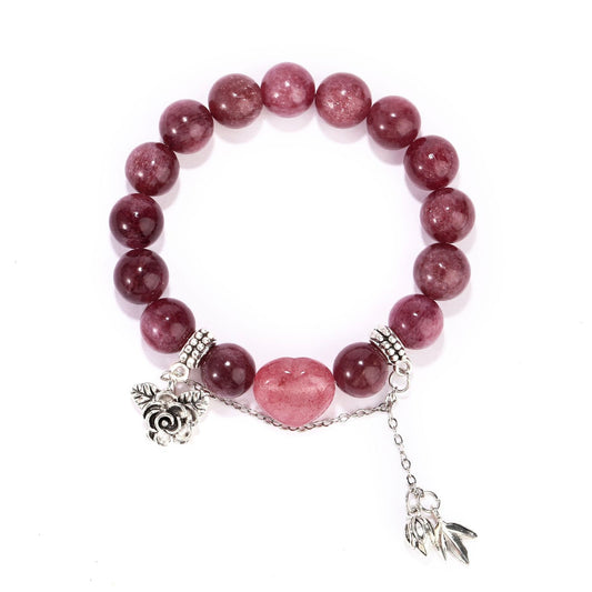 Front view of strawberry quartz bracelet with heart centerpiece and silver charms