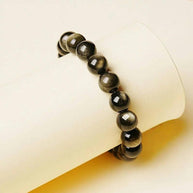 Golden Obsidian bracelet wrapped around soft yellow prop